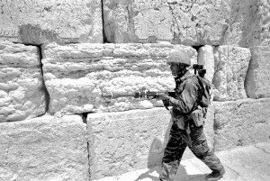 Israeli soldier walks in front of Western Wall in Jerusalem's Old City